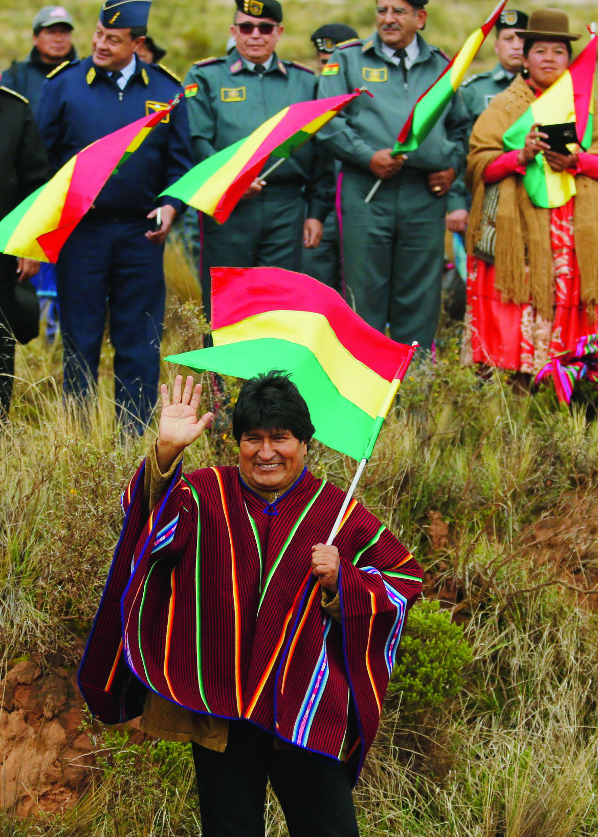 Bolivian President Evo Morales waves to competitors of the 2018 Dakar Rally inn Guaqui, Bolivia, Thursday, Jan. 11, 2018. (Andres Stapff/Pool Photo via AP) Peru Bolivia Dakar Rally