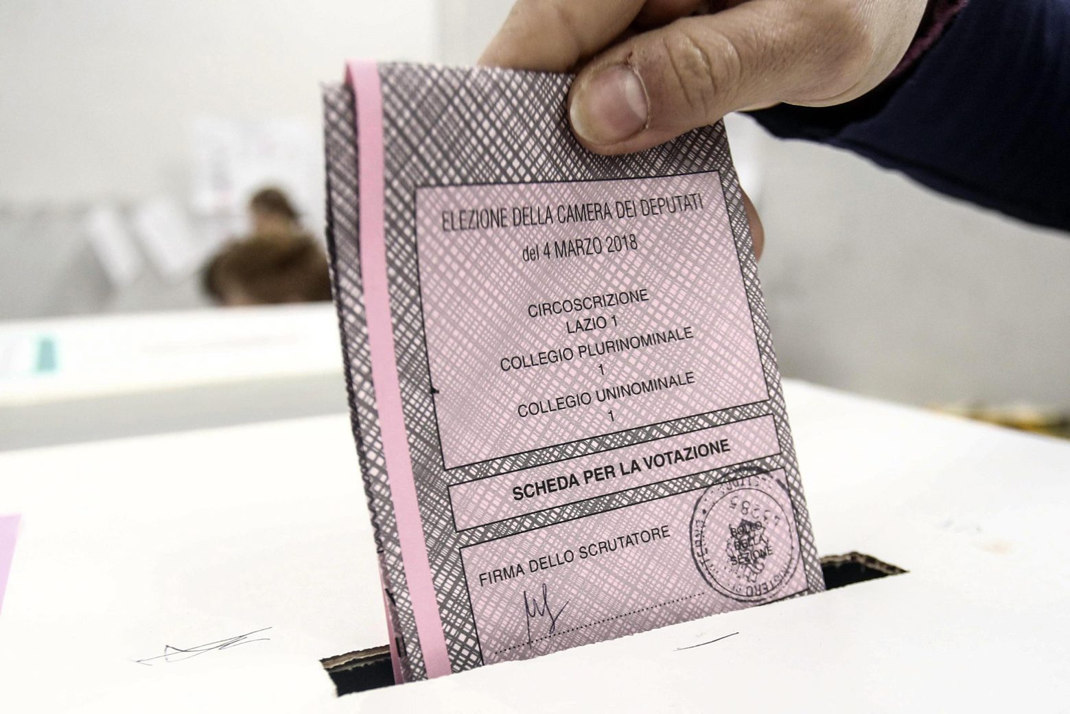 A person cast his ballot at a polling station in Rome, Sunday, March 4, 2018. More than 46 million Italians were voting Sunday in a general election that is being closely watched to determine if Italy would succumb to the populist, anti-establishment and far-right sentiment that has swept through much of Europe in recent years. (Giuseppe Lami/ANSA via AP) Italy Elections