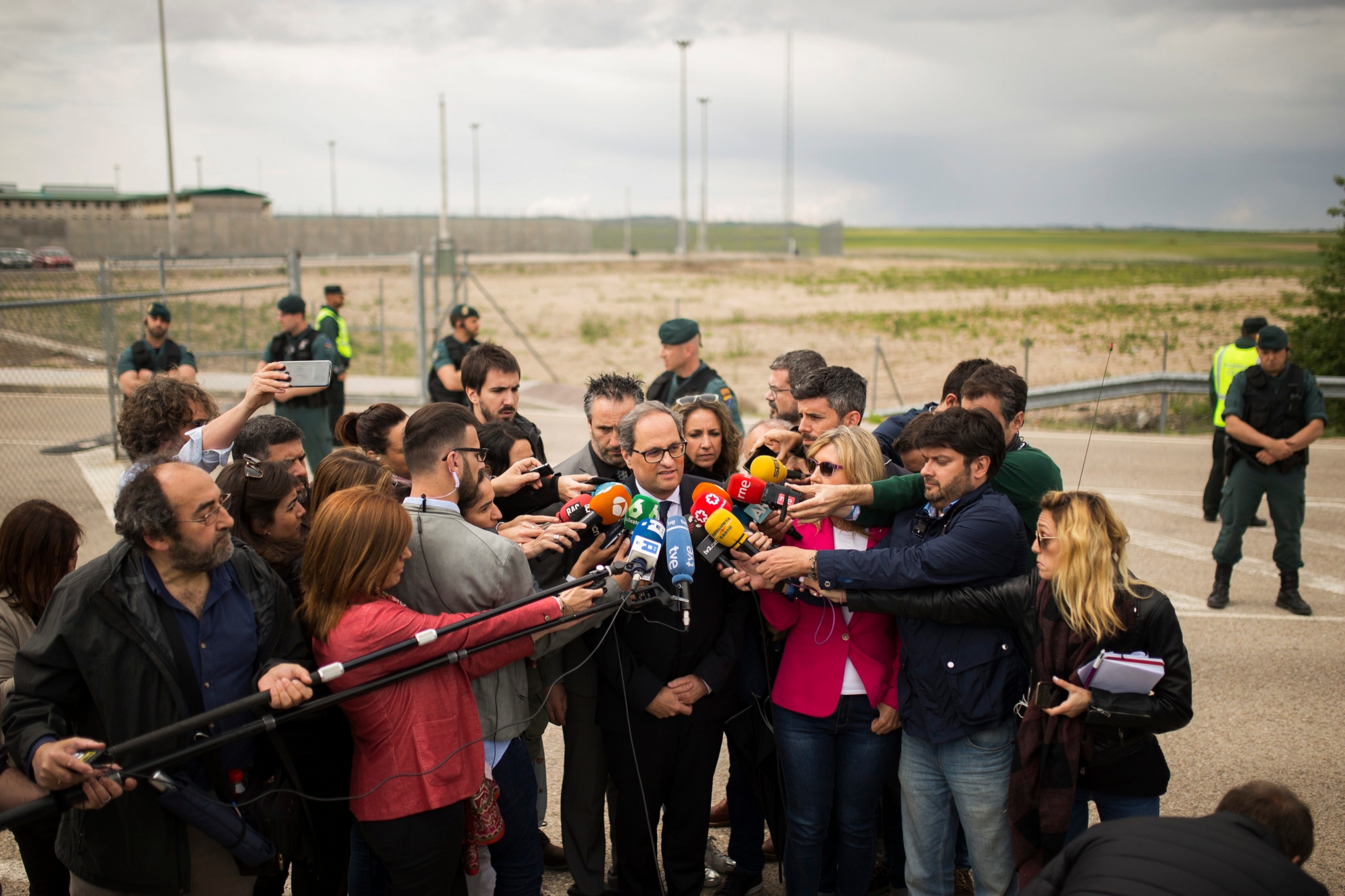 Newly elected regional Catalan President Quim Torra, center, makes a statement to the media after visiting jailed Catalan politicians at the Estremera prison, near Madrid, Monday, May 21, 2018. New Catalan leader Quim Torra named Jordi Turull and Josep Rull, who are both in pre-trial detention, and Antoni Comin and Lluis Puig, who are fugitives in Belgium, as proposed members of his government on Saturday. (AP Photo/Francisco Seco) Spain Catalonia
