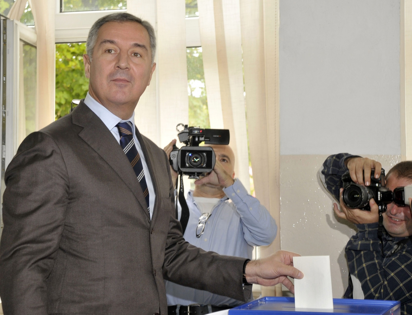 Montenegro?s ruling coalition of longtime leader Milo Djukanovic casts his ballot at the polling station in downtown Podgorica, Montenegro, Sunday, Oct. 14, 2012. Djukanovic is again a favorite to win weekend parliamentary elections in the tiny Balkan nation seeking membership in the European Union. (AP Photo/Risto Bozovic)