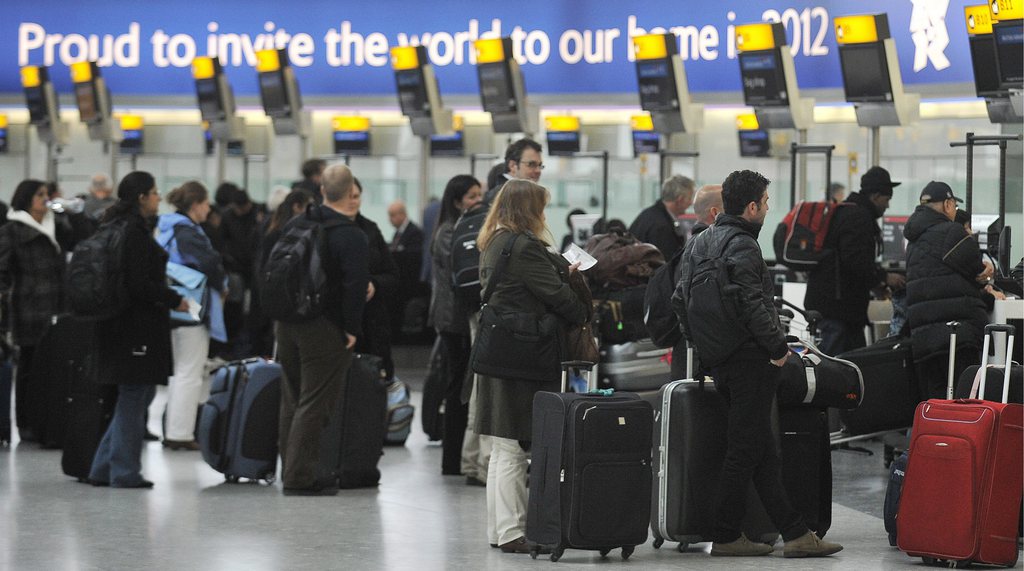 epa03147674 Passengers at Heathrow Airport's Terminal 5 in London, Britain, 16 March 2012. Reports suggest that the UK's flagship airport Heathrow may struggle with passenger traffic during the London 2012 Olympic Games. While athletes and VIPs will pass through dedicated security lanes, ordinary members of the public may experience long delays.  EPA/ANDY RAIN