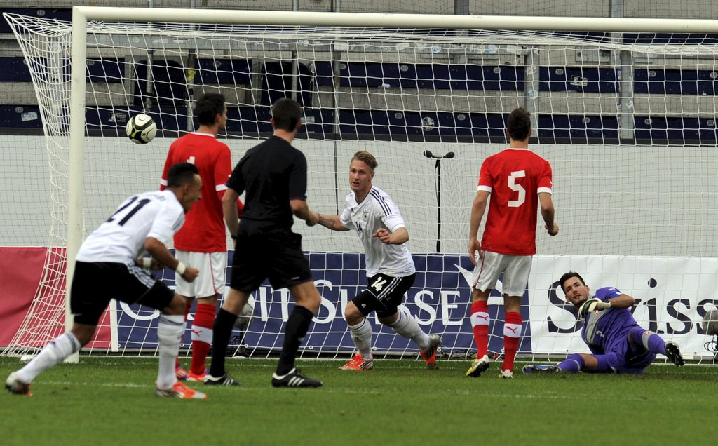 Germany's Sebastian Polter, centre, celebrates after the first goal for Germany, against Swiss Goalie Roman Buerkis, right, during the U21 UEFA European Soccer Championship qualification second leg match between Switzerland and Germany, at the swissporarena stadium in Luzern, Switzerland, Tuesday, October 16, 2012. (KEYSTONE/Karl Mathis)