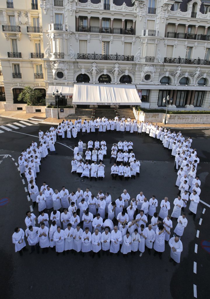 240 chefs from 25 countries, representing 5 continents and 300 stars from the Michelin Guide, pose with French chef Alain Ducasse, to celebrate the 25th anniversary of his restaurant Le Louis XV, Saturday, Nov. 17, 2012, in Monaco. (AP Photo/Lionel Cironneau)
