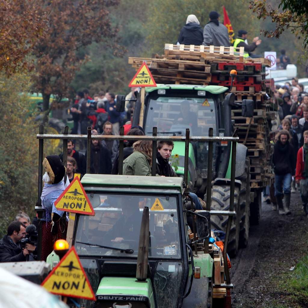 Demonstrators walk along a road near Notre Dame des Landes, western France Saturday Nov. 17, 2012, as part of a protest against a project to build an international airport, in Notre Dame des Landes, near Nantes. The project was decided in 2010 and the international airport should open by 2017. (AP Photo/David Vincent)