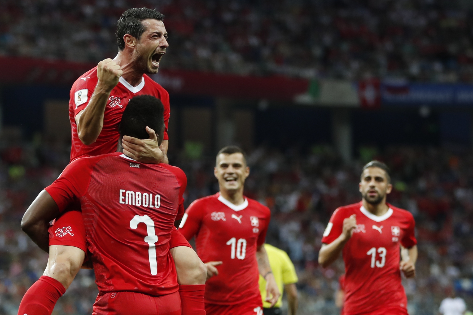 Switzerland's Blerim Dzemaili, top, celebrates with his teammates, from left, Breel Embolo, Granit Xhaka and Ricardo Rodriguez after scoring his side's first goal during the group E match between Switzerland and Costa Rica, at the 2018 soccer World Cup in the Nizhny Novgorod Stadium in Nizhny Novgorod , Russia, Wednesday, June 27, 2018. (AP Photo/Natasha Pisarenko)