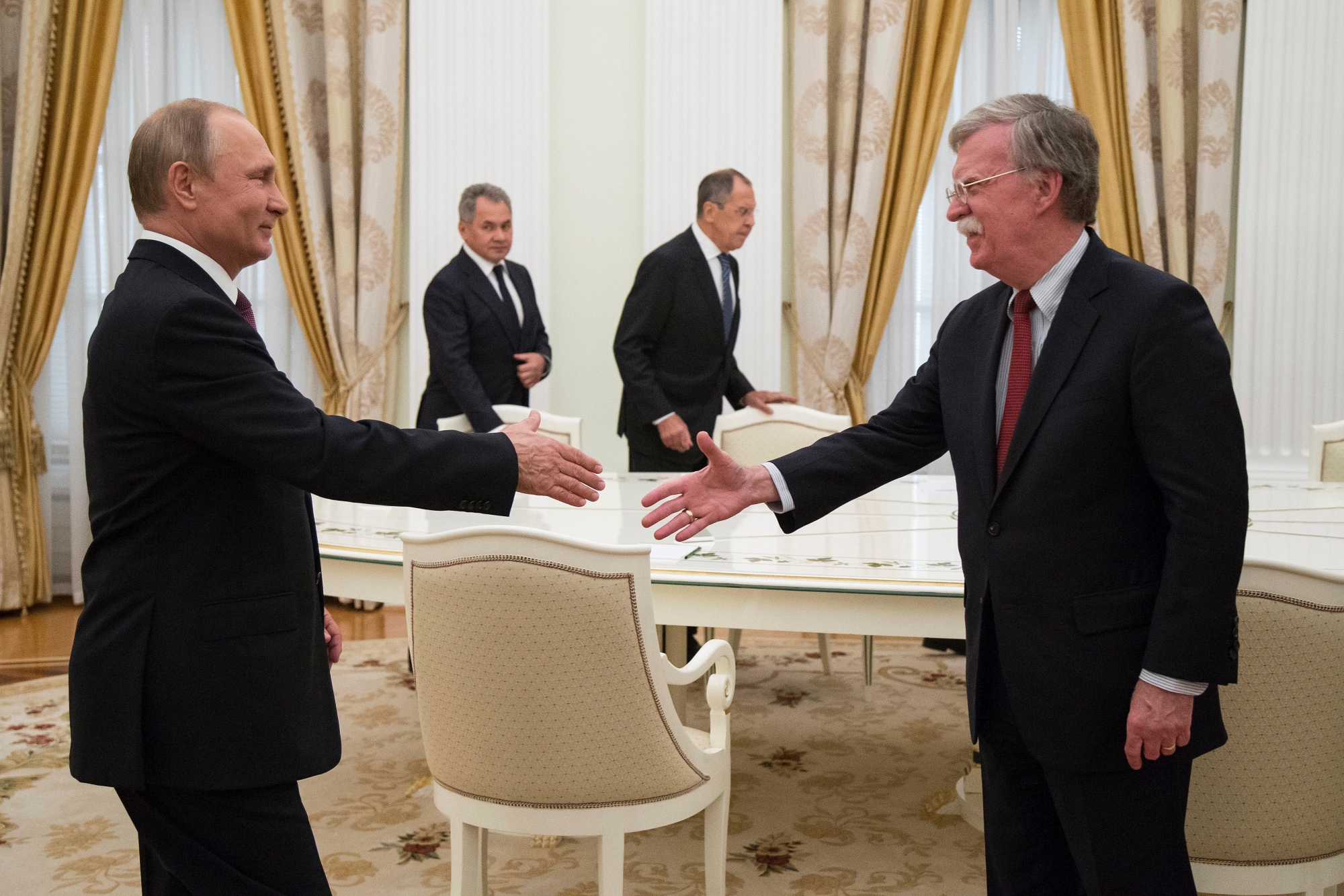 epa06843897 Russian President Vladimir Putin (L) shakes hands with US National security advisor John Bolton (R) during their meeting in the Kremlin in Moscow, Russia, 27 June 2018. US President Donald Trump's national security advisor is in Moscow to lay the groundwork for a possible US-Russia summit.  EPA/ALEXANDER ZEMLIANICHENKO / POOL POOL PHOTO RUSSIA USA DIPLOMACY