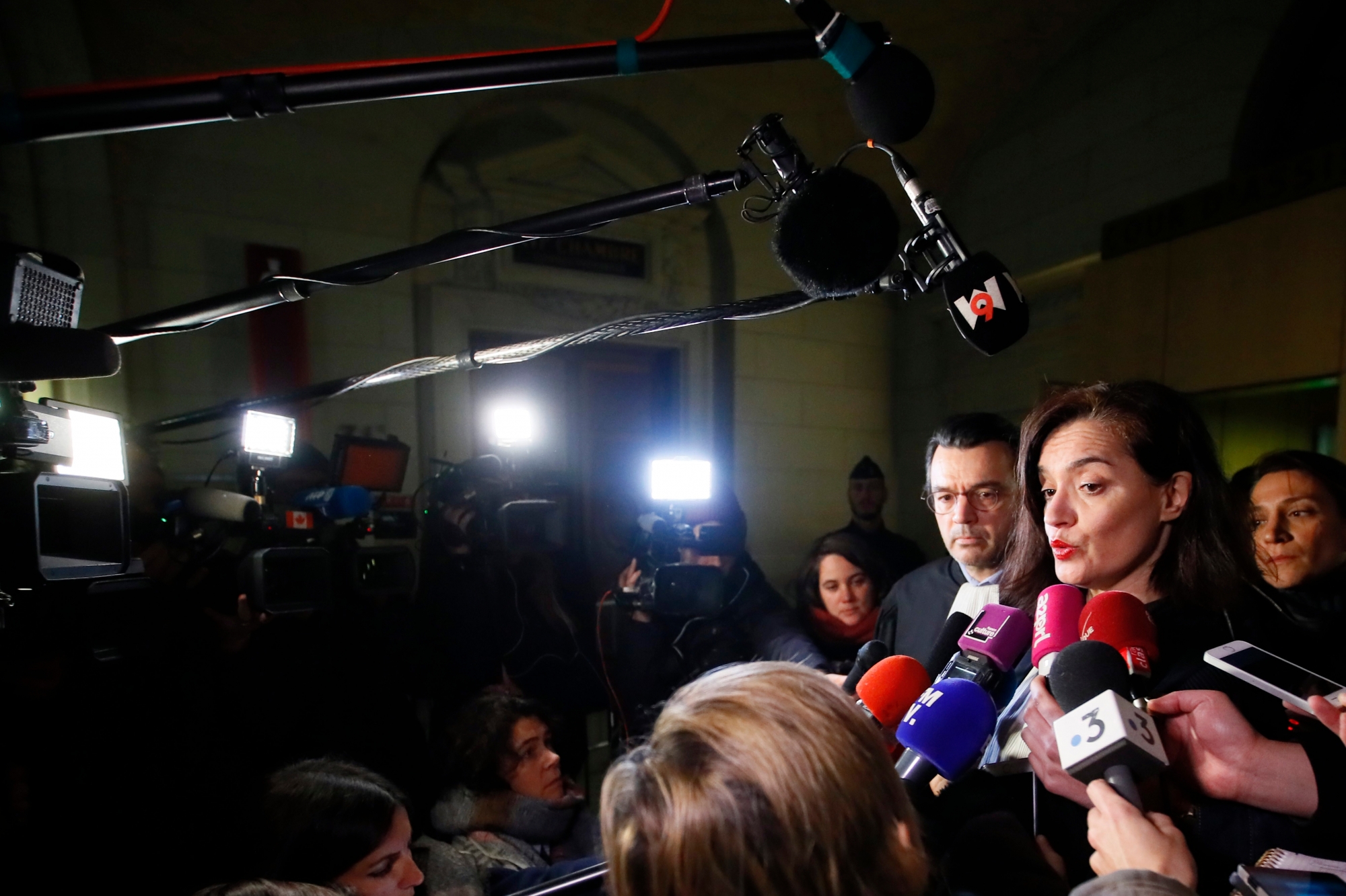 French lawyers Mario Stasi and Sophie Obadia, right, defending a Canadian tourist speak to the press after walking out of the court in Paris, Thursday, Jan. 31, 2019. Two anti-gang French policemen have been found guilty of raping a 39-year-old Canadian woman at a renowned Paris police headquarters in 2014. (AP Photo/Francois Mori) France Rape Trial