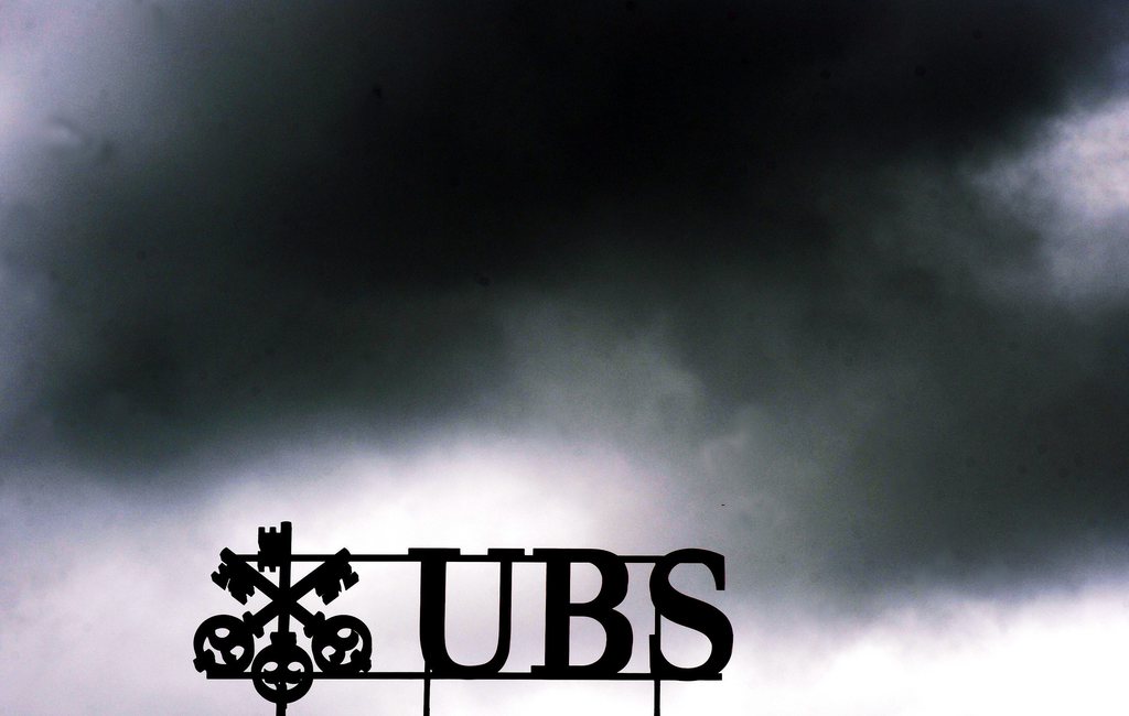 FILE - The July 14, 2011 file photo shows dark clouds above the UBS logo on the bank's head office in Zurich, Switzerland.  UBS AG agreed Wednesday, Dec. 19, 2012 to pay some US$ 1.5 billion in fines to international regulators following a probe into the rigging of a key global interest rate. In admitting to fraud, Switzerland's largest bank became the second bank, after Britain's Barclays PLC, to settle over the rate-rigging scandal. The fine, which will be paid to authorities in the U.S., Britain and Switzerland, also comes just over a week after HSBC PLC agreed to pay nearly US$ 2 billion for alleged money laundering.  (AP Photo/Keystone, Walter Bieri)