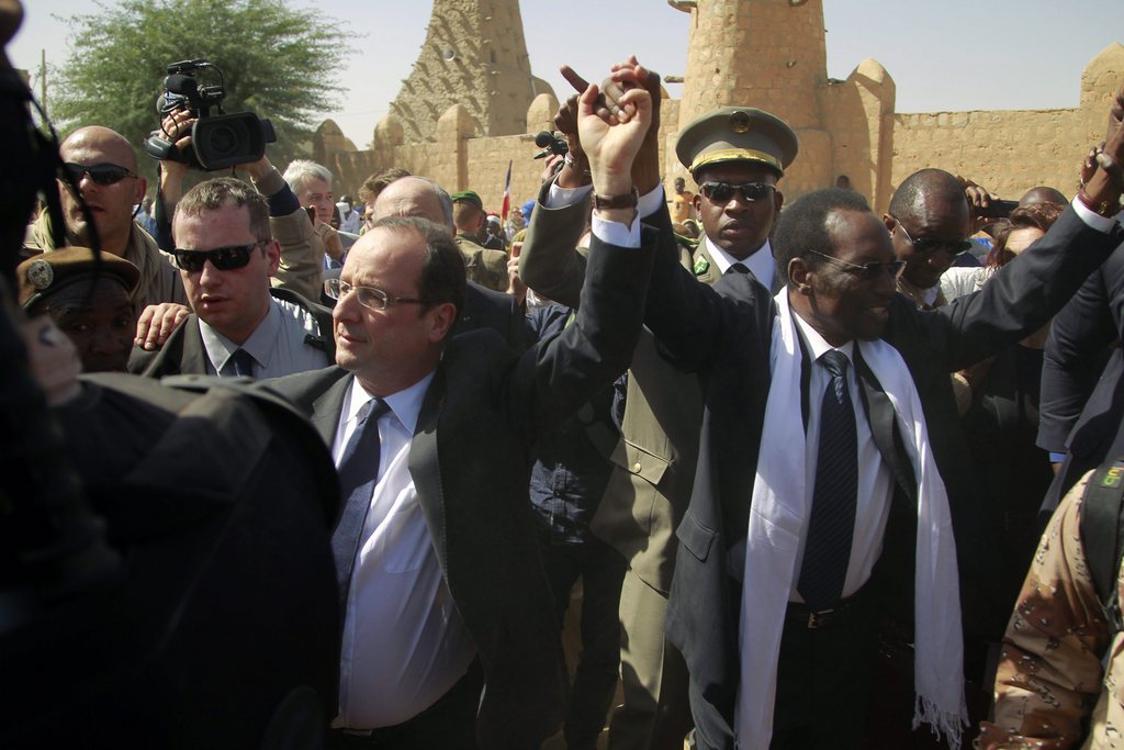 French President Francois Hollande  holds hands with Mali's interim President Dioncounda Traor? in Timbuktu, Mali, Saturday Feb. 2, 2013.(AP Photo/Jerome Delay)