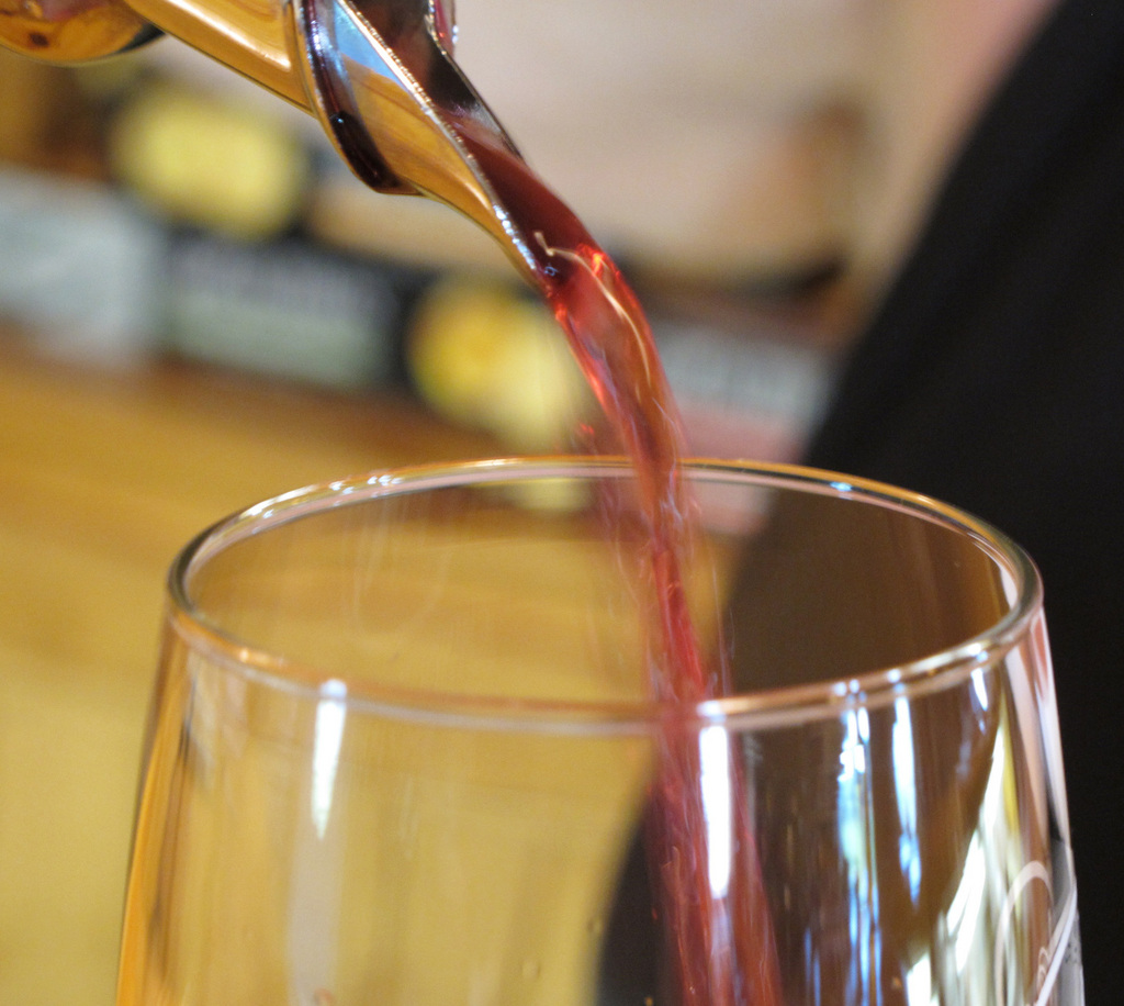 In this July 29, 2011 photo, a server pours a glass of Marquette wine into a tasting glass at the Richwood Winery in Richwood, Minn. Since it takes about three to four years for vines to mature, the Marquette wine has only recently hit store shelves.  (AP Photo/Dave Kolpack)