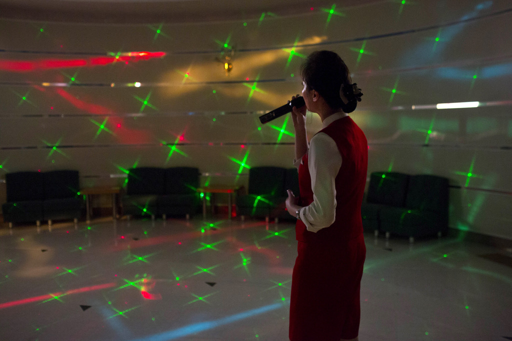A North Korean woman sings karaoke at the Hyangsan Hotel at the foot of Mount Myohyang, North Korea, Saturday, Feb. 23, 2013. (AP Photo/David Guttenfelder)