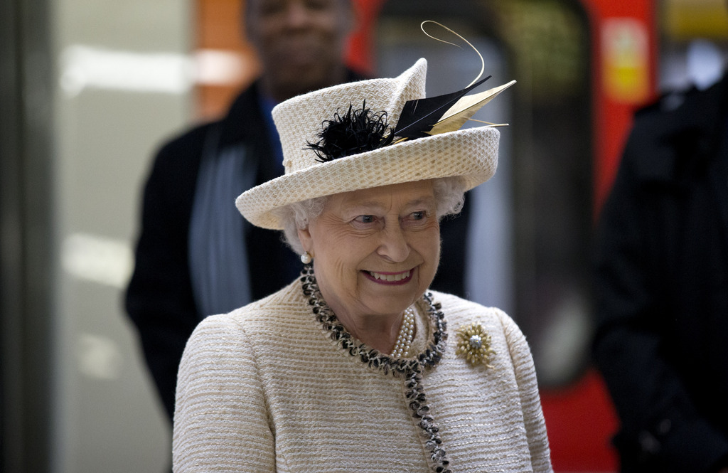 Britain's Queen Elizabeth II smiles as she visits Baker Street underground station in London, to mark the 150th anniversary of the London Underground, Wednesday, March 20, 2013.  The Queen made her first public engagement in more than a week Wednesday after cancellations following her hospitalization for a stomach bug. The British head of state joined her husband Prince Philip and their granddaughter-in-law, Kate, for the event marking the 150th anniversary of London's sprawling subway system, affectionately known as the Tube.  (AP Photo/Matt Dunham)