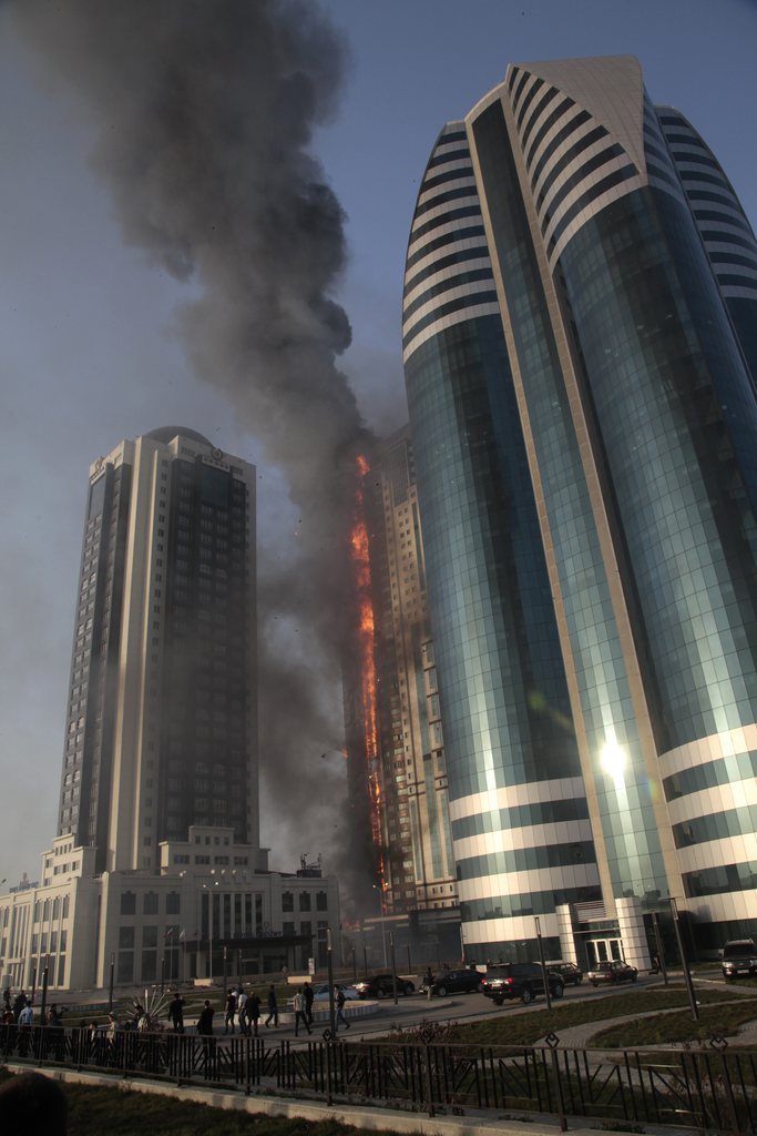 A fire rages in a high-rise apartment building in provincial capital Grozny, Russia, Wednesday, April 3, 2013. French actor Gerard Depardieu reportedly received an apartment in the complex of buildings as a gift from Chechen leader Ramzan Kadyrov. People are not living in the building yet. ( AP Photo/Musa Sadulayev)