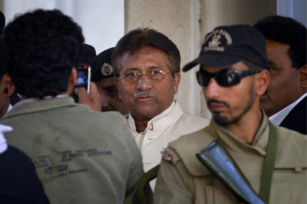 Pakistan's former president and military ruler Pervez Musharraf, center, leaves after appearing in court in Rawalpindi, Pakistan on Wednesday, April 17, 2013. Musharraf appeared in court to seek bail in Benazir Bhutto's assassination case. Pakistan's Supreme Court ordered Musharraf to respond to allegations that he committed treason while in power, and barred him from leaving the country only weeks after he returned. (AP Photo/Anjum Naveed)