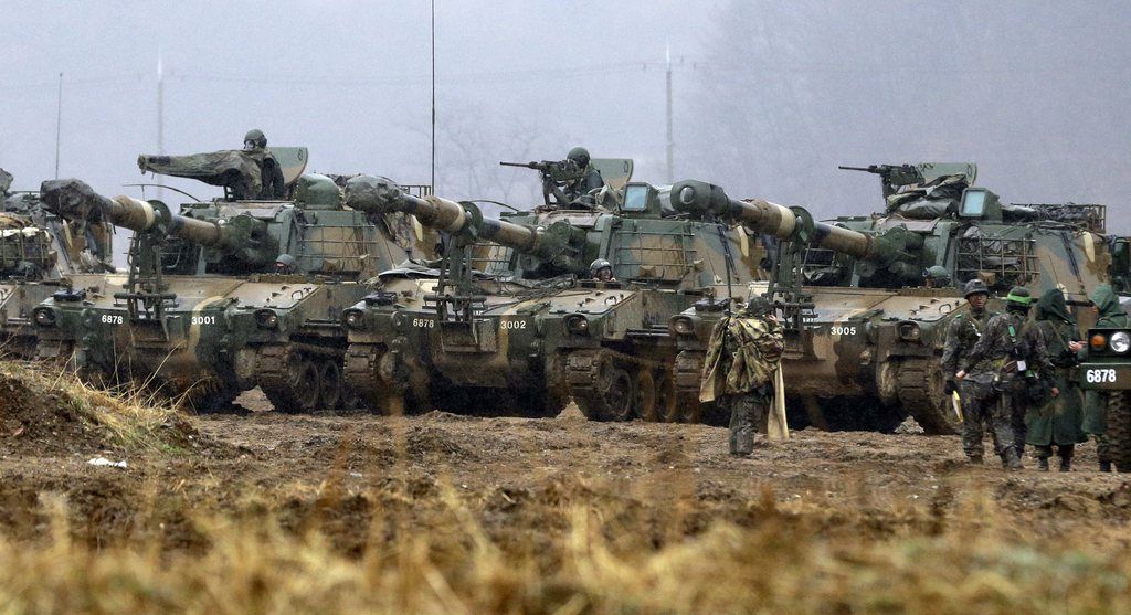 South Korean Army K-55 self-propelled howitzer are parked during their military exercise in the border city of Paju, north of Seoul, South Korea, Tuesday, April 2, 2013. North Korea vowed Tuesday to restart a nuclear reactor that can make one bomb's worth of plutonium a year, escalating tensions already raised by near daily warlike threats against the United States and South Korea. (AP Photo/Lee Jin-man)