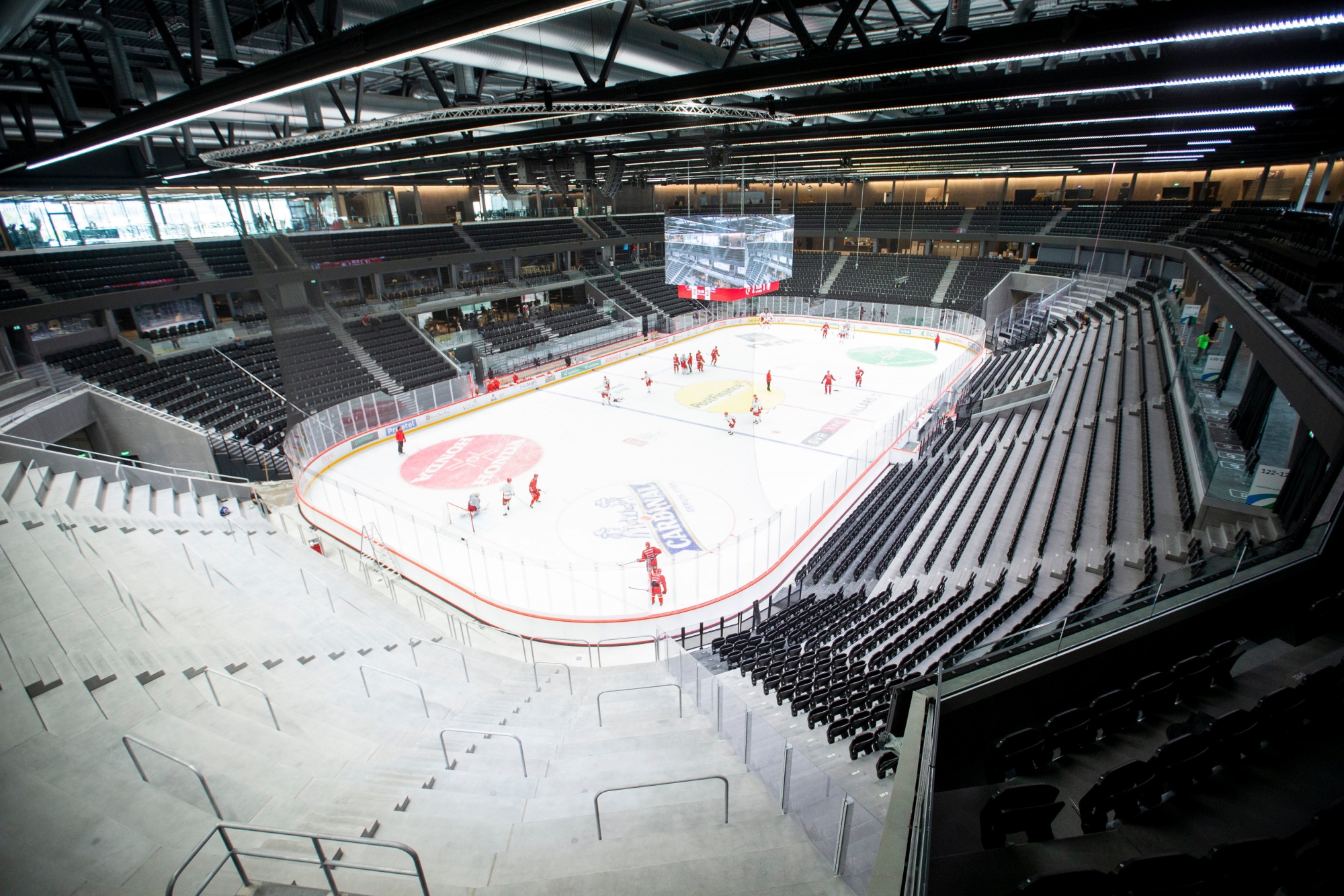 Le Lausanne Hockey Club griffant pour la première fois la glace de la Vaudoise aréna vue depuis le haut du "mur" qui accueillera dès mardi soir les supporters debout des Lions.