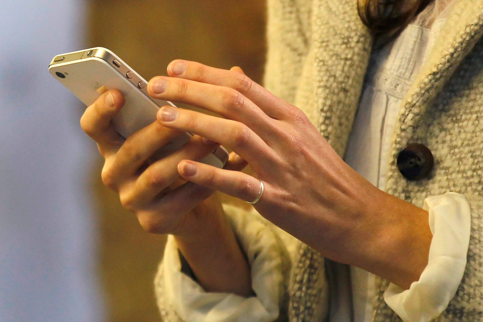 A woman uses her smartphone in central London, Wednesday, Nov. 14, 2012. UK Lawyers say the mounting tally of those arrested and convicted of making offensive comments through social media, shows the problems of a legal system trying to regulate 21st-century communications with 20th century laws. Civil libertarians say it is a threat to free speech in an age when the internet gives everyone the power to be heard around the world. (AP Photo/Sang Tan) Britain Freedom Of Tweets