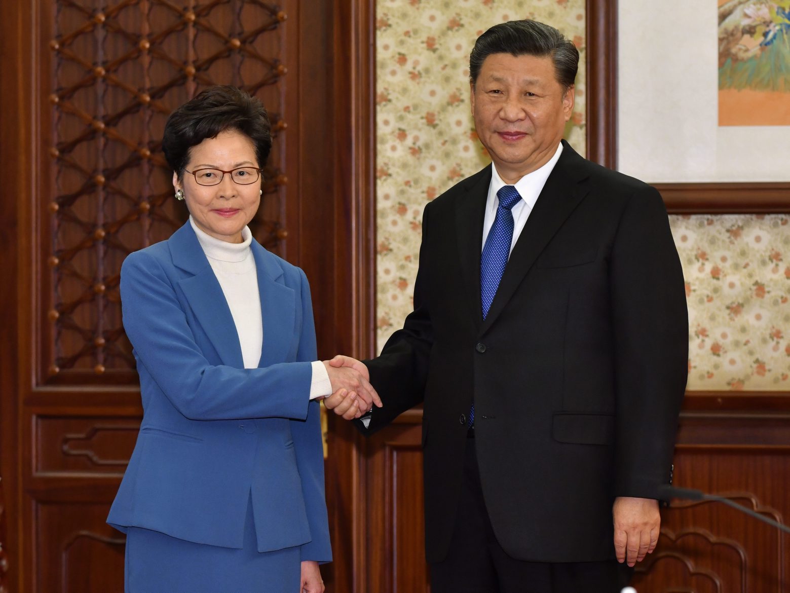 epa08075468 A handout photo made available by Hong Kong Government's Information Services Department (ISD) shows Hong Kong Chief Executive Carrie Lam (L) being greeted by Chinese President Xi Jinping (R) during their meeting in Beijing, China, 16 December 2019. Lam is on her third day of her annual duty visit to Beijing.  EPA/HONG KONG GOVERNMENT'S INFORMATION SERVICES DEPARTMENT HANDOUT  HANDOUT EDITORIAL USE ONLY/NO SALES CHINA HONG KONG GOVERNMENT CHIEF EXECUTIVE