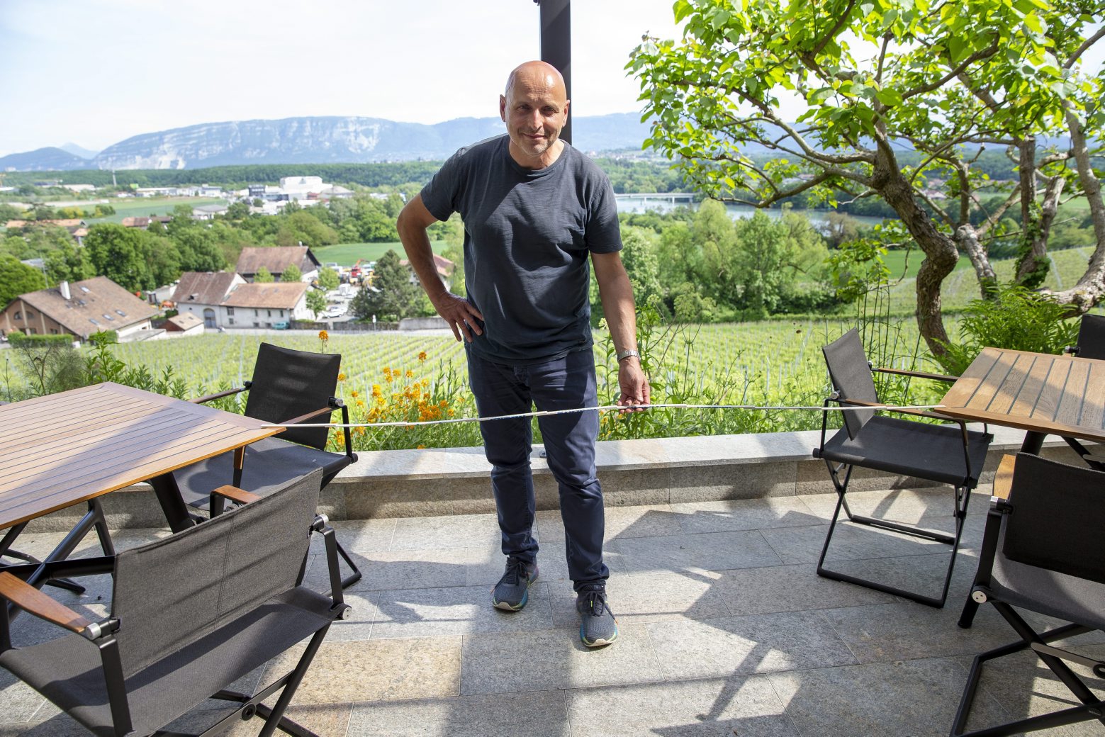 Swiss Chef Philippe Chevrier prepares his terrace at the restaurant of Domaine de Chateauvieux for the reopening by respecting the sanitary rules during the Swiss state of emergency due to the coronavirus COVID-19, in Satigny near Geneva, Switzerland, Friday, May 8, 2020. In Switzerland from 11 May, loosening measures slowing down the ongoing pandemic of the COVID-19 disease, which is caused by the SARS-CoV-2 coronavirus, become effective by step. Classroom teaching at primary and lower secondary schools will again be permitted. Shops, markets, museums, libraries and restaurants will be able to reopen under strict compliance with precautionary measures. (KEYSTONE/Salvatore Di Nolfi) SWITZERLAND PANDEMIC CORONAVIRUS COVID-19