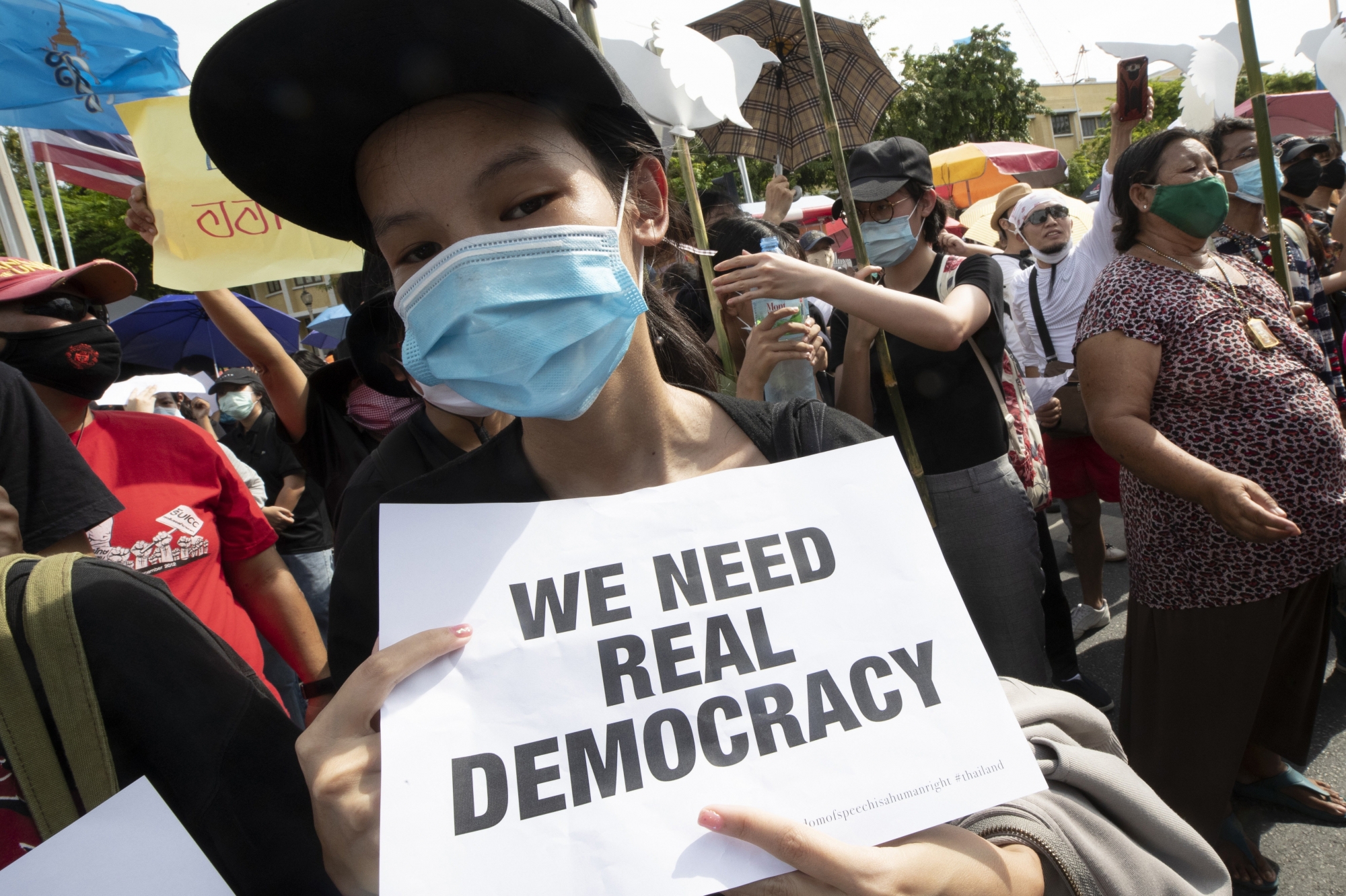 A pro-democracy student holds a poster during a rally in Bangkok, Thailand, Sunday, Aug, 16, 2020. Protesters have stepped up pressure on the government if it failed to meet their demands, which include holding of new elections, amending the constitution, and an end to intimidation of critics. (AP Photo/Sakchai Lalit) ArcInfo